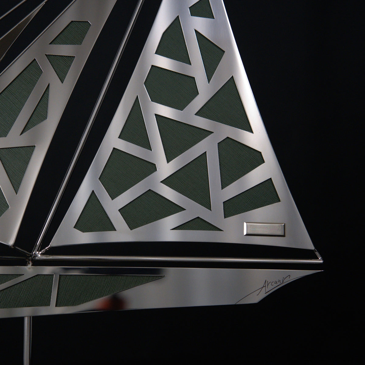 Vesper, openwork steel sail over green Saffiano leather