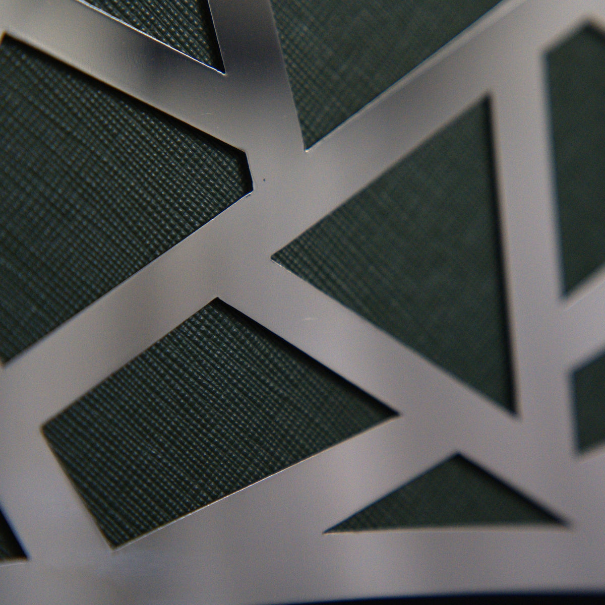 Vesper, green Saffiano leather behind the steel lattice